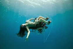 woman in wheelchair, underwater, with scuba gear