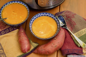 image of 2 bowls of curried sweet potato soup, an Instant Pot, colorful napkins, spoons, and sweet potatoes