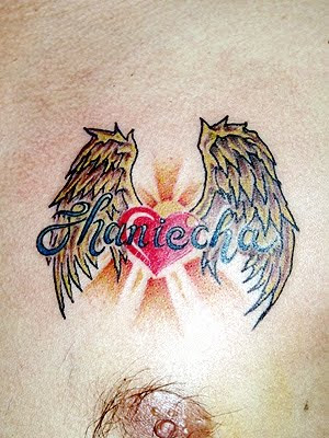 small angel wings tattoo combinated whit heart and tattoo script on chest 