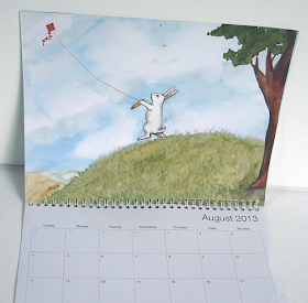 2013 calendar with rabbits - page shown is bunny flying a kite