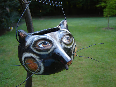 paper mache Halloween candy bucket shaped like a raccoon's face