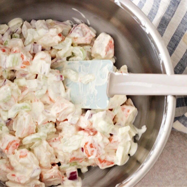 process image of cold shrimp salad recipe salad mixed up in bowl with spatula