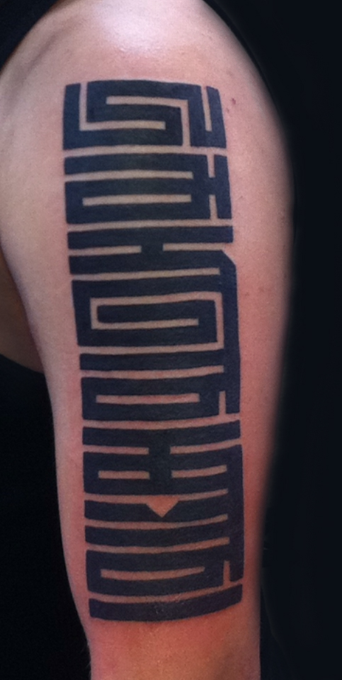 A sleeve tattoo of the upper arm This is in the distinct angular script 