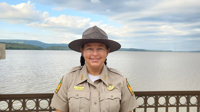 Photo of speaker Sasha Bowles with Lake Dardanelle in the background.
