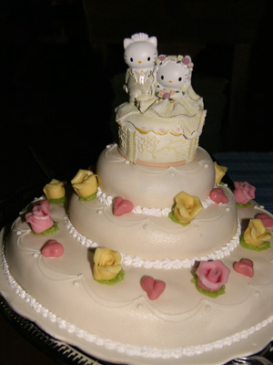 Gorgeous wedding cake with yellow and pink sugar roses and Hello Kitty Cake 