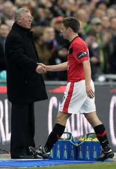 Manchester United manager Alex Ferguson shakes hands with Michael Owen