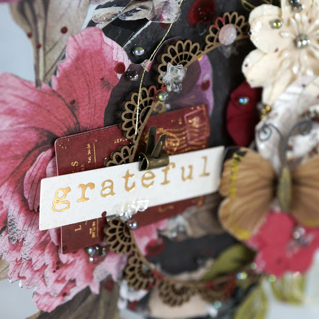 Grateful Mixed Media Altered Art: Prima Marketing midnight garden, paper flowers, Pretty Pale butterfly; Tim Holtz distress mica flakes, Idea-ology tiny clips; Reneabouquets designer glass beads fairy opal