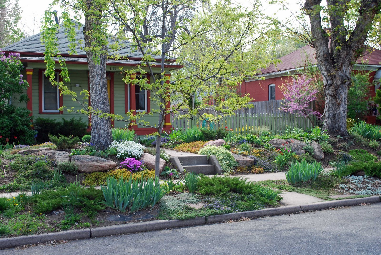 Big boulders for structure and a succession of colorful plantings for ...