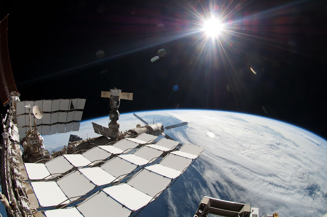 The bright Sun, a portion of the International Space Station and Earth's horizon are featured in this image photographed during the STS-134 mission's fourth spacewalk in May 2011. The image was taken using a fish-eye lens attached to an electronic still camera.   Image Credit: NASA Explanation from: http://www.nasa.gov/multimedia/imagegallery/image_feature_2059.html