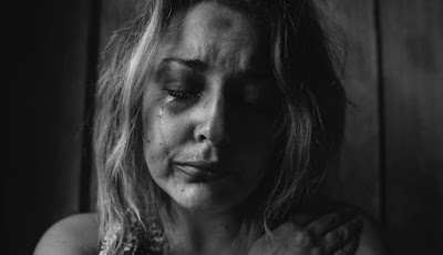 A woman in pain, crying.