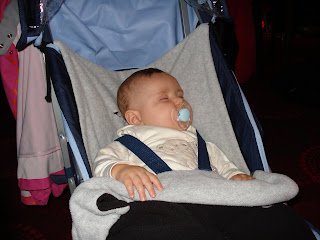 Baby Boy asleep in his pram in the noisy Holiday Club