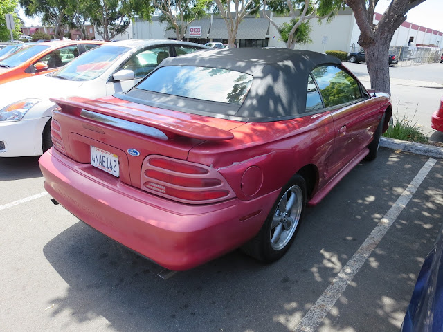 Creased quarter panel on 1995 Ford Mustang before collision repairs at Almost Everything Auto Body