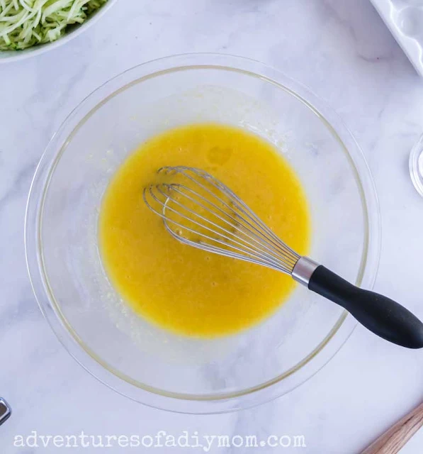 eggs, milk, oil and sugar mixed for zucchini muffins