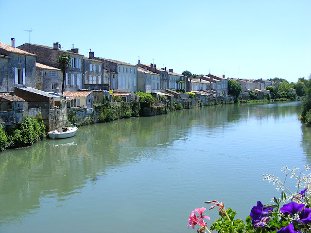 Houses backing on to the Charente in Saint Savinien. France. Photographed by Susan Walter. Tour the Loire Valley with a classic car and a private guide.