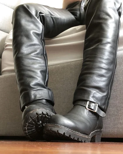Superior POV of leather boots and black pants no face