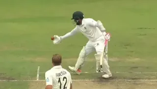 a person in a white uniform playing cricket
