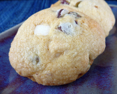 Puffy Pistachio Cookies with White and Semi-Sweet Chocolate Chips, photographed on a blue plate