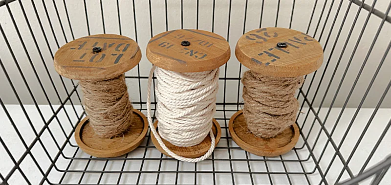 wooden spools with twine and stencils in basket