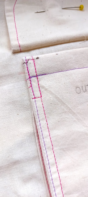 Image shows a top corner of the pocket with a rectangle of stitching.