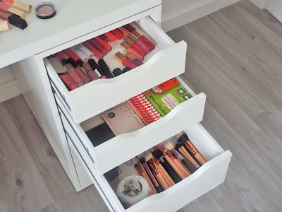 Wide angled shot of right hand side of my dressing table draws, showing my lip products in top draw, face palettes in second draw and makeup brushes in third draw.