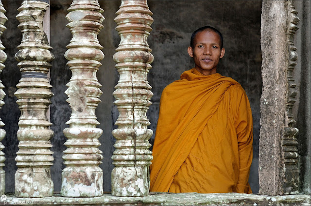 Stone columns and Buddhist monk in Angkor Wat, Cambodia