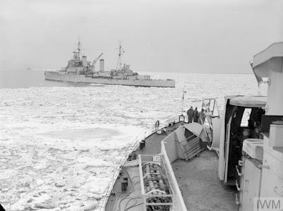 HMS Mounts Bay pushes through pack ice towards the cruiser HMS Ceylon who is waiting to transfer ammunition and provisions off the west coast of Korea in 1952