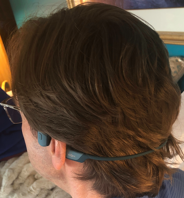 Photo of man wearing Shokz OpenRun Pro Bluetooth bone conduction headphones