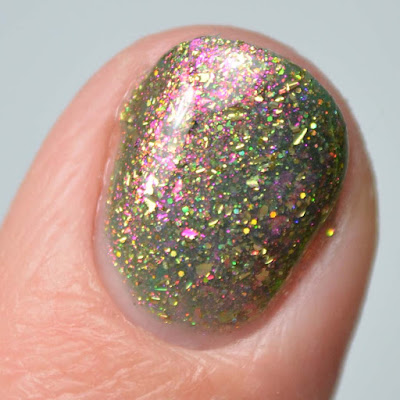 green nail polish with color shifting flakies close up swatch