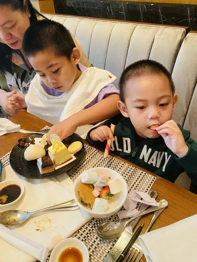 Miguel and Rafa eating sweets at High Street Cafe at Shangri-La The Fort