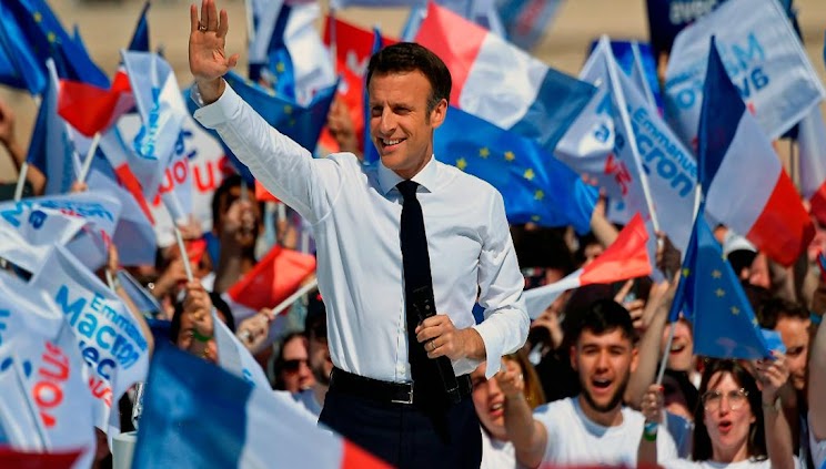 Projections showed that French President Emmanuel Macron was on track to win a second term by defeating far-right leader Marine Le Pen in presidential elections on Sunday.