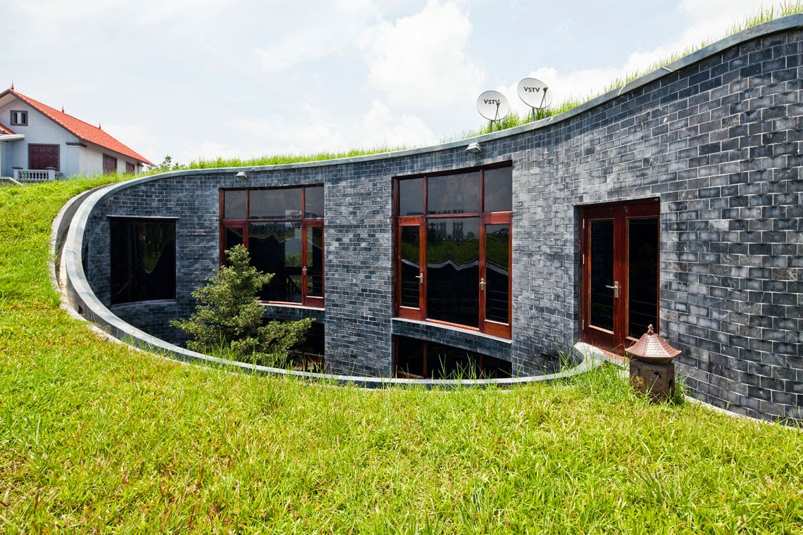 Stone House With Grass Roof and Central Garden