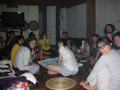 playing 윷놀이 (yunnori), traditional Korean game played with sticks