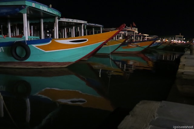 River boats at the pier next to the Central Market at night.