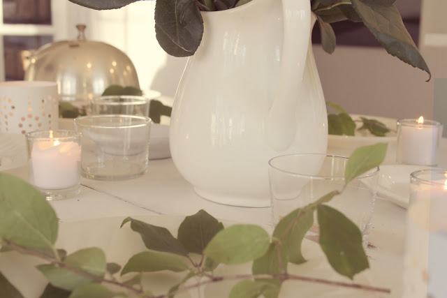 White farmhouse table with ironstone, candlelight, and greenery by Hello Lovely Studio