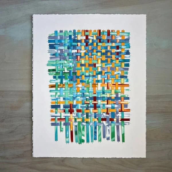 multicolor paper weaving on white deckle-edge background paper