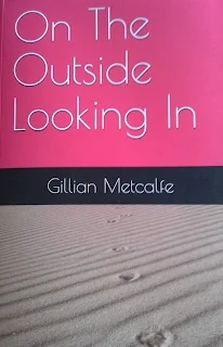the front cover of my first book with pink panel and a trail of camel footprints in the sand