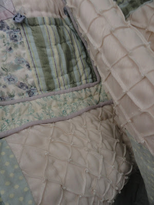 a multi-textured bed quilt, close up of loose folds