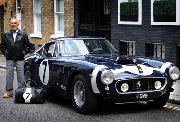  driver Sir Stirling Moss and his iconic 1961 Ferrari 250 SWB above 