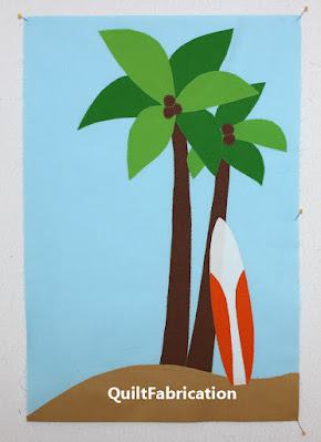 palm trees and a white and orange surfboard against the trunk
