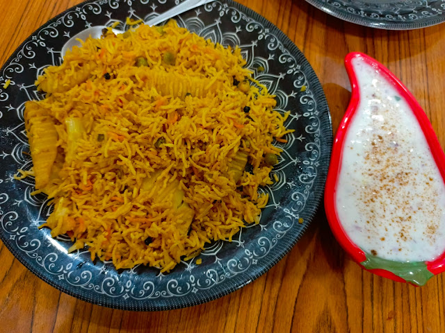 Vegetable Rice served in a white dish garnished with fresh herbs and colorful veggies - a flavorful vegetarian meal