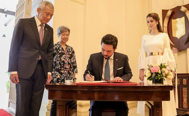 Princess Rajwa wore a white Calmina crepe maxi dress by Roksanda. Prime Minister Lee Hsien Loong and his wife Ho Ching