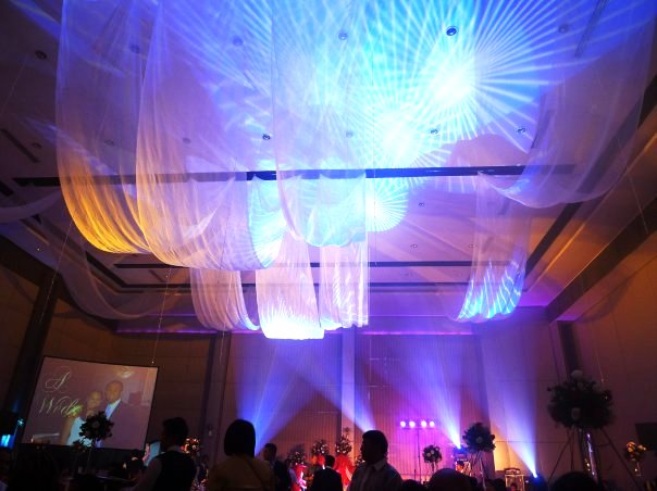 A wedding event White organza swag for the ceiling