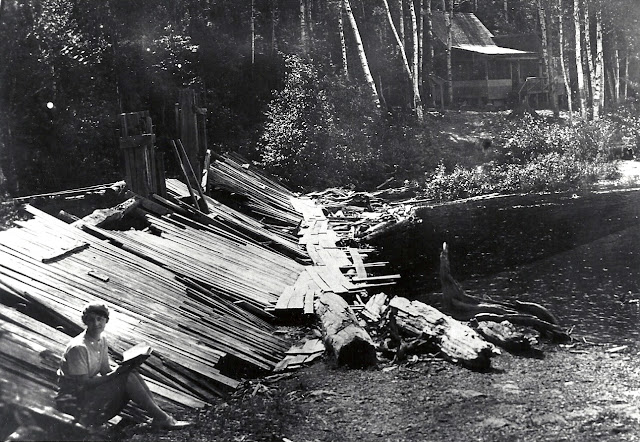 Mary Putnam on the Dam in front of the camp, Drew's Lake, ME