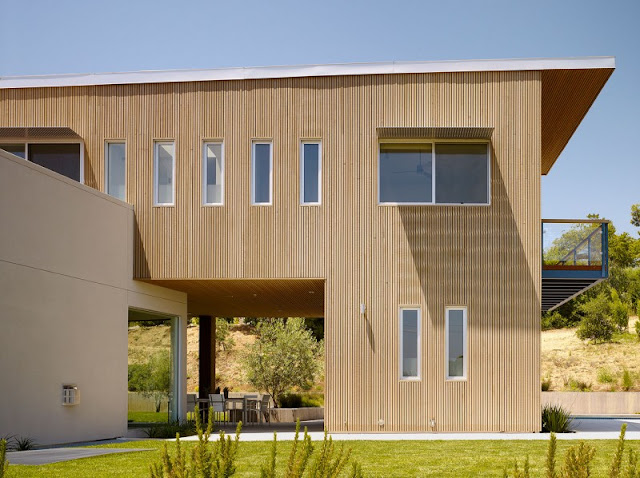 Wide Glass Windows and Wooden Wall in Home Exterior near the Grass Yard