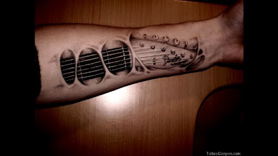 Guitar Tattoo embedded in the arm.