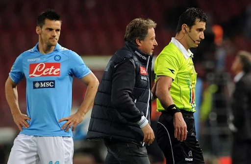 Referee Daniele Doveri is led from the pitch with an injury