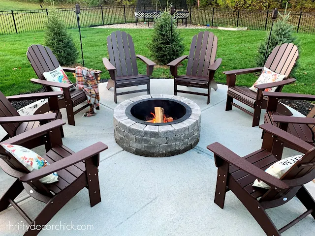 concrete patio with fire pit and chairs