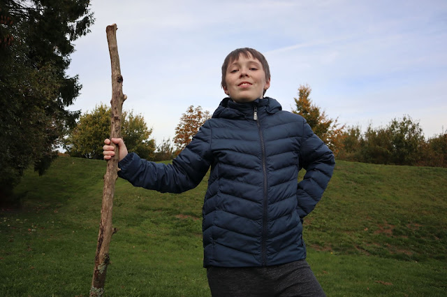 Boy holding stick wearing Reima Falk Winter Jacket