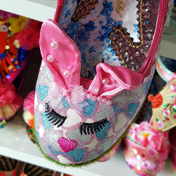 close up of embroidered bunny face on front of heart print glitter shoe