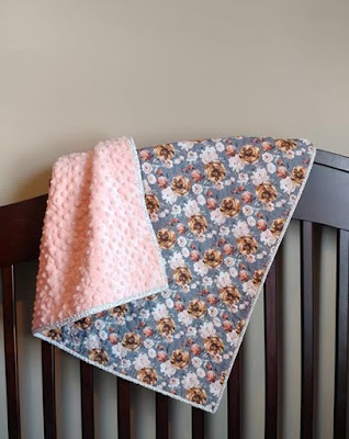 This trendy floral whole cloth quilt with soft minky back is the perfect baby quilt for a girl!